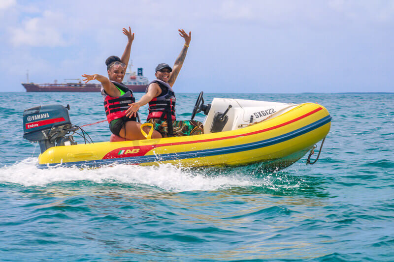Two guests driving a yellow Rhino mini speed boat in Sint Maarten